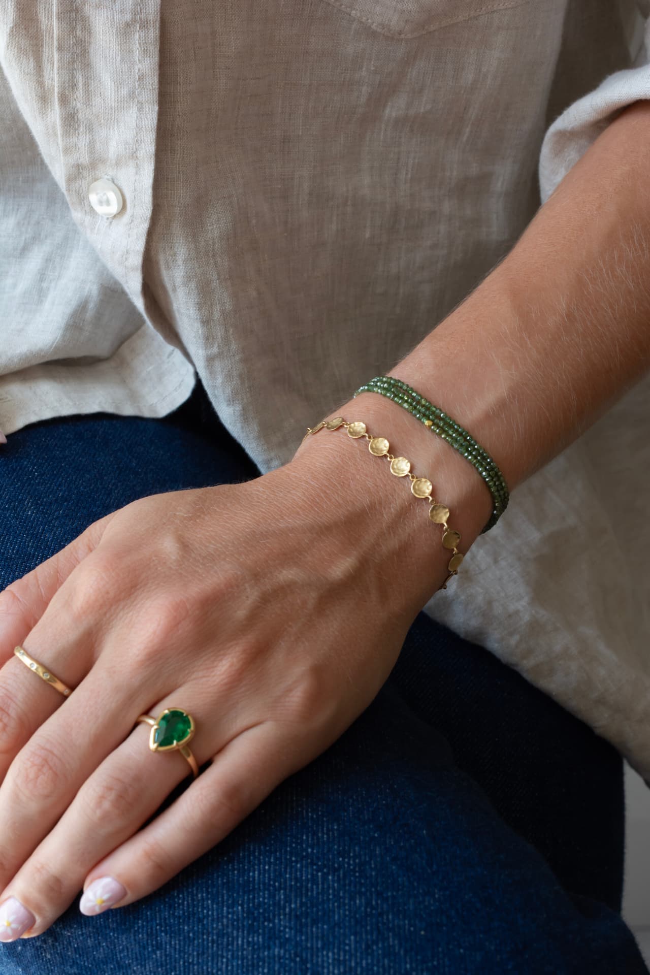 Green gemstone ring with gold and green gemstone bracelets