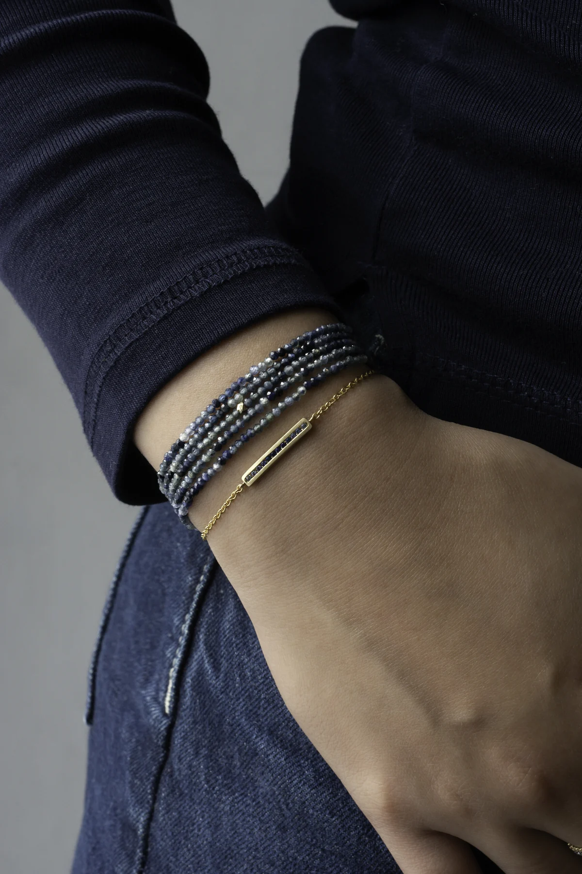 Gradient blue sapphire wrap bracelet and gold bangle