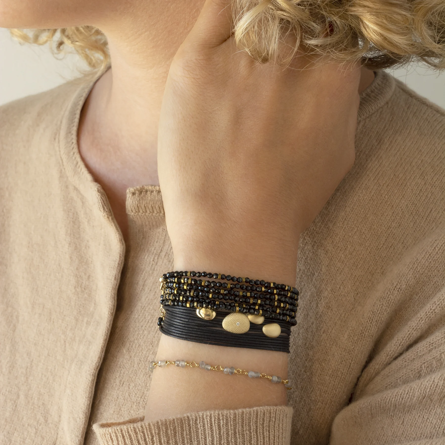 Spinel gemstone wrap bracelet styled with gold bangles