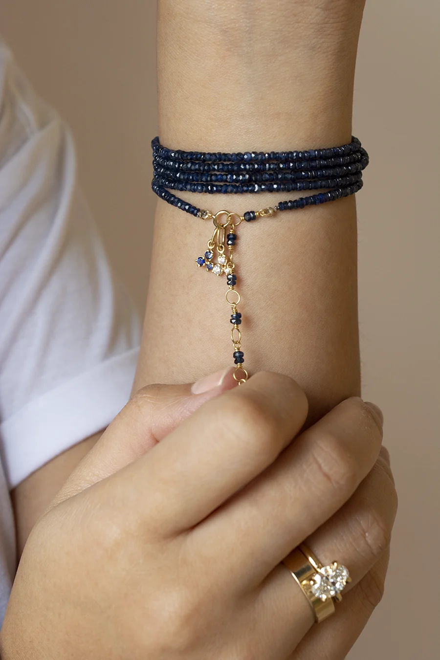 Blue gemstone wrap bracelet with a gold charm